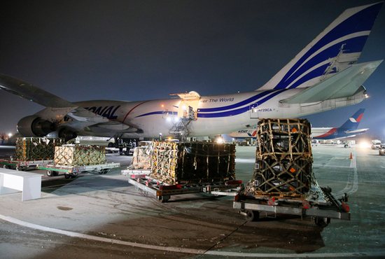 Workers unload a shipment of military aid delivered as part of the United States of America's security assistance to Ukraine, at the Boryspil International Airport outside Kyiv, Ukraine, Jan. 25, 2022. 