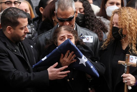 The mother of Officer Wilbert Mora of the New York Police Department is seen outside St. Patrick's Cathedral in New York City after her son's funeral Mass Feb. 2, 2022. Mora, 27, was fatally shot in the line of duty while responding to a domestic violence call in Harlem Jan. 21 and died of his wounds Jan. 25.