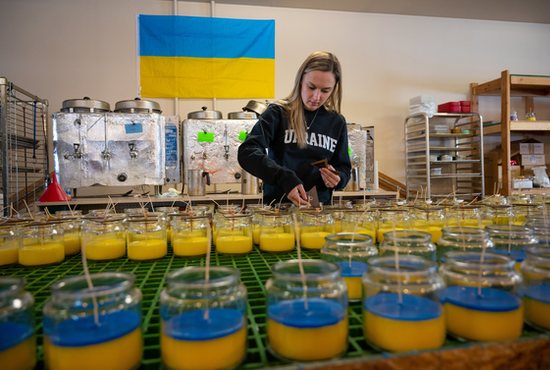 Christiana Gorchynsky Trapani, owner of Door County Candle Co. in Sturgeon Bay, Wis., works on Ukrainian Candles which are being sold there as a fundraiser to support victims of war in Ukraine March 1, 2022. Trapani is an Ukranian American who has family living in the Ukraine.