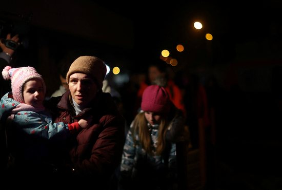 Ukrainian refugees who fled the Russian invasion wait to board a train to be able to return to Ukraine outside the train station in Przemysl, Poland, March 29, 2022. The U.N. refugee agency announced that the number of refugees fleeing Ukraine since Feb. 24 has surpassed 4 million people. 