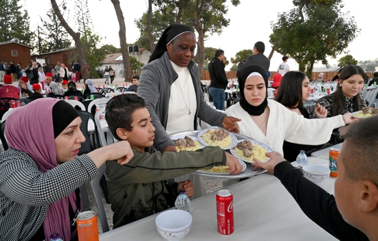  Benedictine Sister Elodie Bouda of Burkina Faso serves Muslims during an iftar at Abraham's House on the Mount of Olives in East Jerusalem April 9, 2022. Sister Bouda said that, having Muslim family members, it was only natural for her to be able to serve her Muslim neighbors