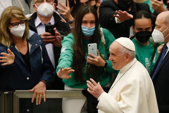 Pope Francis greets the crowd as he leaves his general audience in the Paul VI hall at the Vatican April 6, 2022.