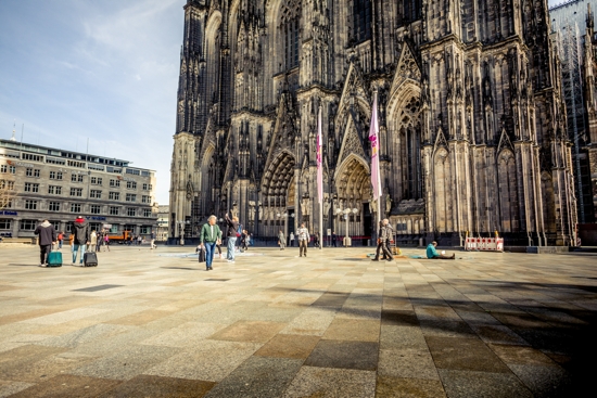 People walk outside the cathedral in Cologne, Germany, March 16, 2020. Catholics in the Archdiocese of Cologne responding to a survey preparing for the 2023 worldwide Synod of Bishops on synodality called for big changes in the church.