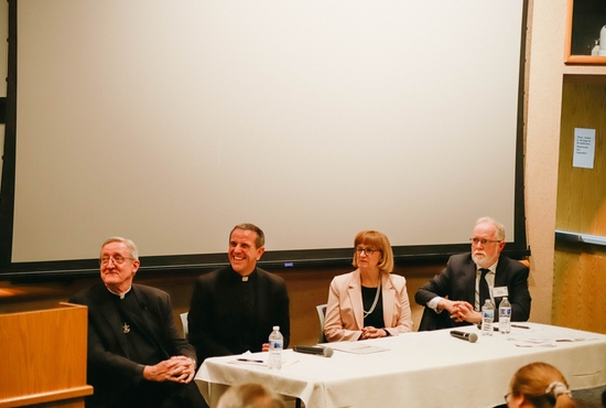 Panelists Holy Cross Father Wilson Miscamble, Jesuit Father Christopher Collins, Anne Maloney and Michael Naughton discuss the state of Catholicism on Catholic university campuses April 26 at the University of St. Thomas in St. Paul. 