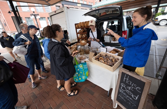 Bridgette Fink, right, helps customers at the St. Paul Farmers Market in downtown St. Paul where she sells bread on Saturdays. Helping her with sales is her sister, Grace, rear left. Both belong to Our Lady of Grace in Edina. DAVE HRBACEK | THE CATHOLIC SPIRIT For any of the closeup detail shots of bread: A sample of Fink’s bread for sale at the farmers market in downtown St. Paul.