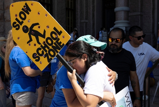 Jazmin Cazares, 17, right, the sister of Jackie Cazares, who was killed in the May 24, 2022, mass shooting at Robb Elementary School in Uvalde, Texas, gets a hug from Mary Morales of Kyle, Texas, during a March for Our Lives rally in Austin, Texas, June 11, one in a series of nationwide protests against gun violence. 