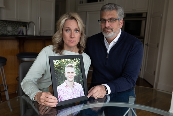 Heather and Randy Bacchus hold a photograph of their late son, Randy Michael Bacchus III, in their home in Mahtomedi.