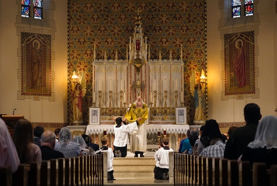 A priest elevates the Eucharist during a traditional Tridentine-rite Mass in July 2021 at St. Josaphat Church in the Queens borough of New York City.