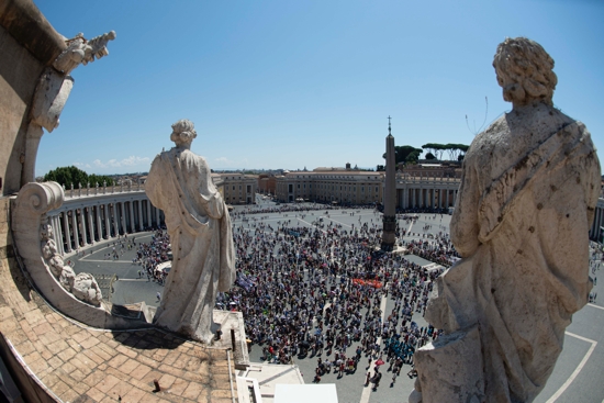 People in St. Peter's Square attend the Angelus led by Pope Francis from the window of his studio overlooking the square at the Vatican July 17, 2022.