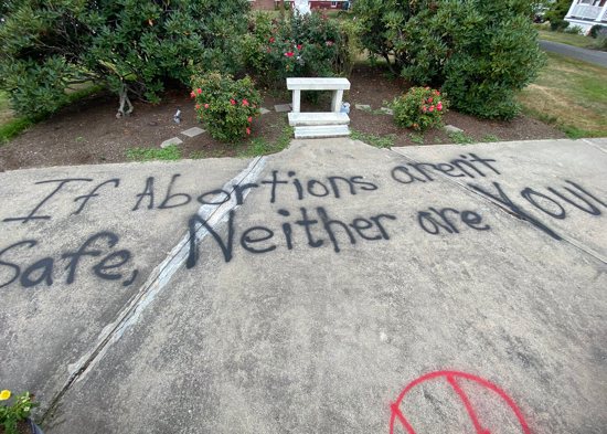 Vandalism is seen near Bethlehem House, a pregnancy center in Easthampton, Mass., Aug. 18, 2022. Vandals spray-painted "Jane's Revenge" on benches located outside the building and the message, "If abortion isn't safe, neither are you."