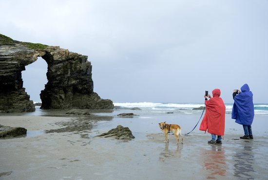 Tourists visit Cathedral Beach at low tide in Ribadeo, Spain, Sept. 25, 2022. In a statement released Sept. 27, 2022, to commemorate World Tourism Day, Cardinal Michael Czerny, prefect of the Dicastery for Promoting Integral Human Development, said a revival of tourism that respect its workers, the environment and tourists can be "a factor of sustainable development" that enriches a country's cultural heritage and benefits host countries and communities.