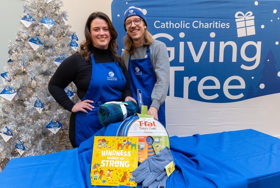 From left, Elizabeth Lyden and Mike Rios-Keating of Catholic Charities will don blue aprons to work at the Giving Tree booth at the Mall of America Dec. 17 and 18.