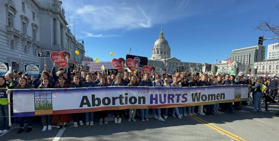 High school and college students hold the Walk for Life banner as pro-life supporters exit Civic Center Plaza to begin the mile-long trek along San Francisco's Market Street Jan. 21, 2023. 