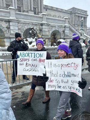 Marie Dill, left, a sophomore homeschooled at Culture of Life Homeschool Academy in St. Paul, and Elizabeth Johnson, a sophomore homeschooled at Mid-Metro Academy in Roseville, carry handmade signs during the Jan. 19 National March for Life in Washington, D.C.